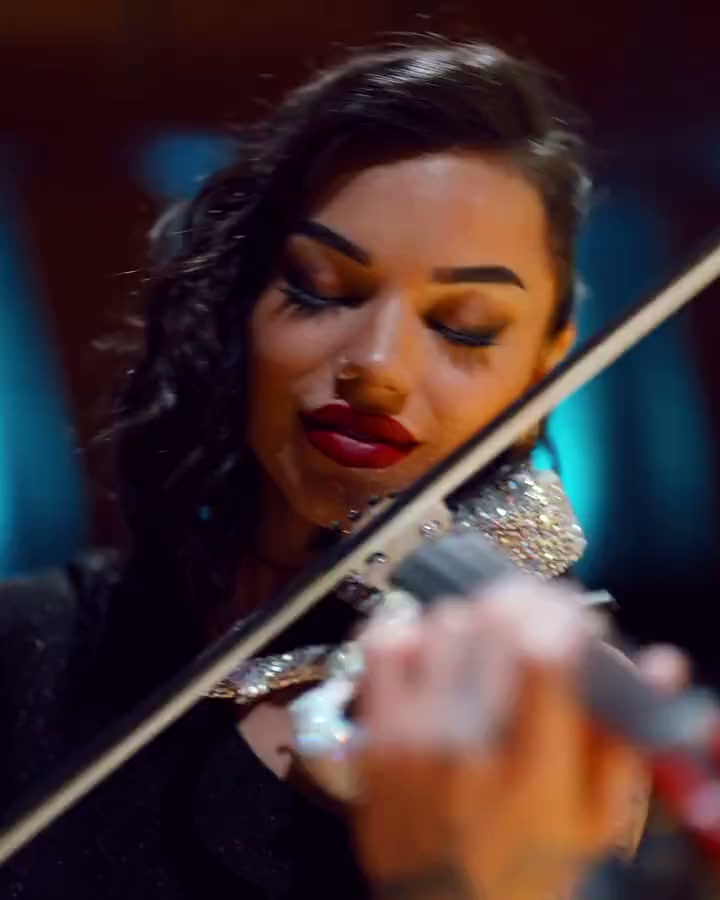 A violinist playing, eyes closed, seen close up